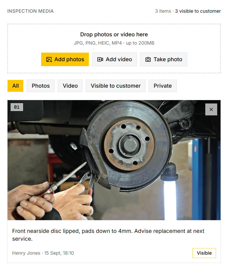 A job's inspection media, showing a photo of a worn brake disc with the technician's note and marked visible to the customer.